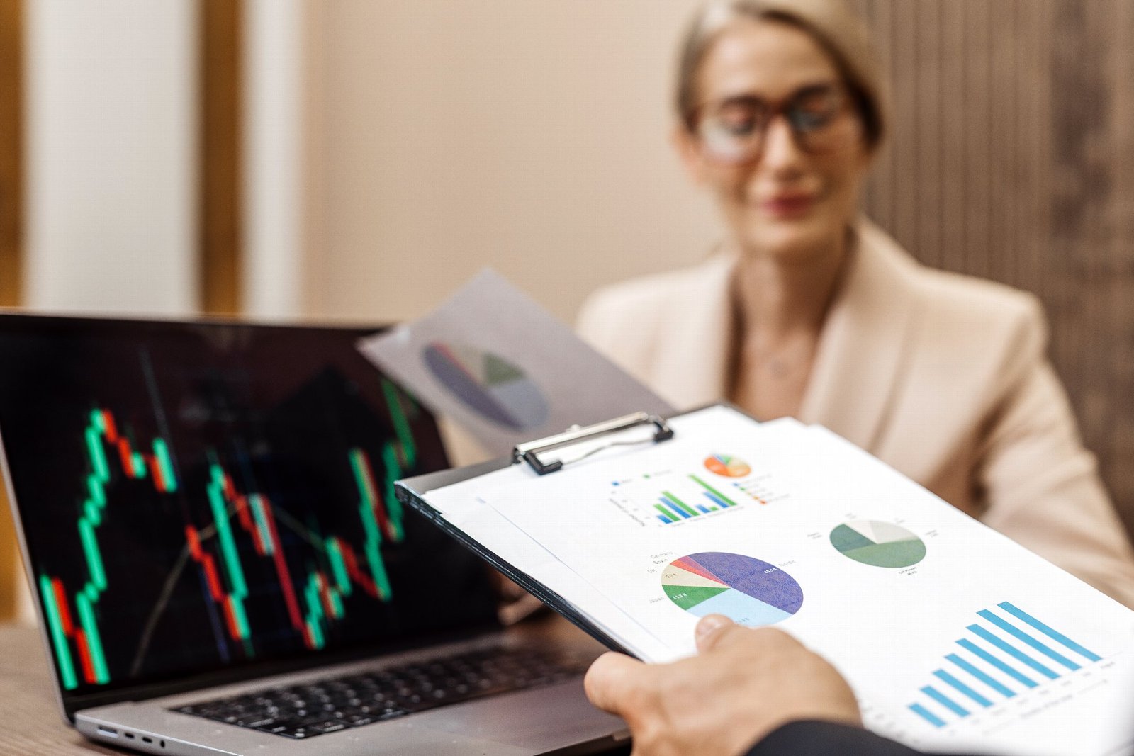 An adviser reviewing business performance data and charts