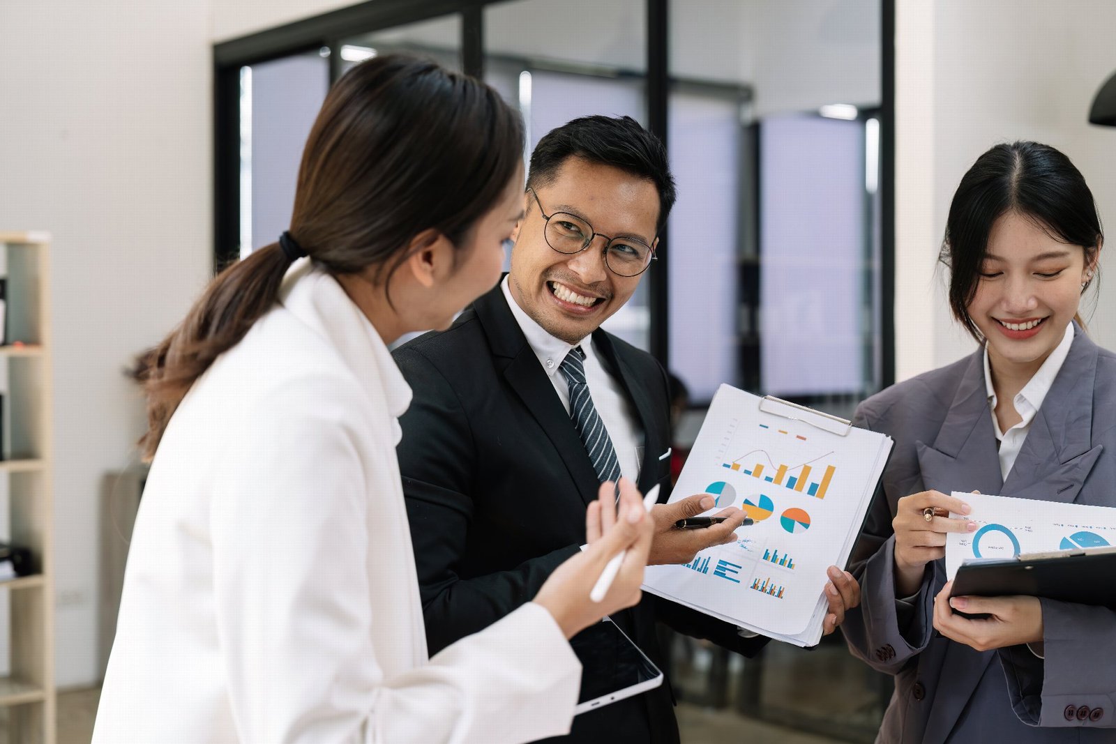 Business advisers discussing performance reports with a client