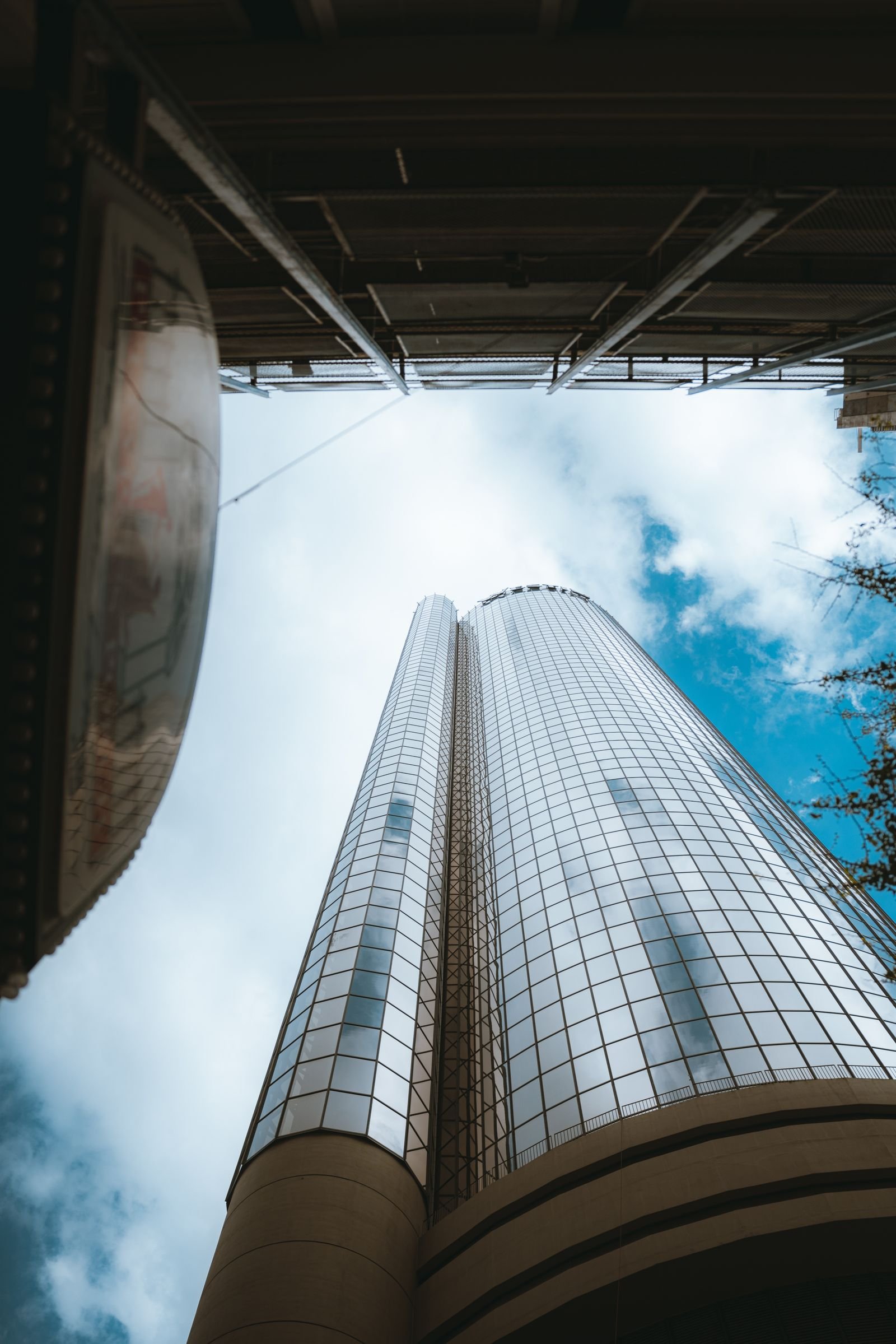 Looking up the glass facade of a city office tower